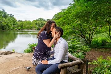 Young Man And Woman Romantic Couple Hug and Kiss In Central Park, New York City