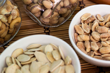Various piles of mixed nuts and seeds