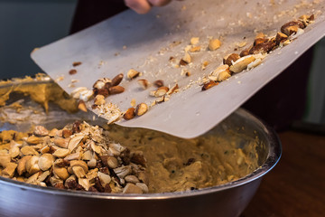 dumping mixed nuts off of a cutting board