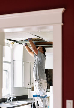 Kitchen: Man Removing Drop Ceiling Tiles