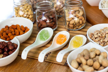 Various piles of mixed gummy candy and nuts 