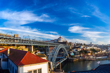 Fototapeta na wymiar Porto Cityscape with Dom Luis I Bridge over Douro River and medieval Ribeira district at sunset, Portugal