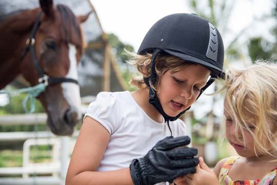 Two sisters at a horse stable