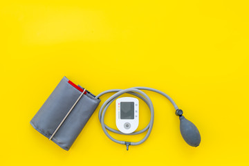 cardiologist work desk with pulsimeter on yellow background top view mock up