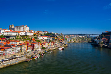 Fototapeta na wymiar Porto Cityscape with Dom Luis I Bridge over Douro River and medieval Ribeira district at day time, Portugal