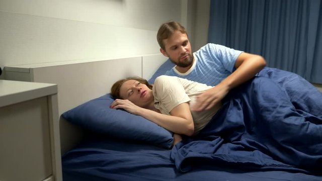 The concept of a problem in a pair. sexual problems. The man shows attention in bed to his woman, and she refused him.