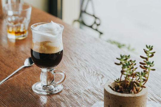 Dark coffee with cream and whiskey