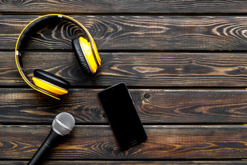 blogger, journalist or musician office desk with mobile phone, microphone and headphones on wooden...