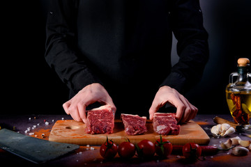 Close up of mans hands spicing the raw meat
