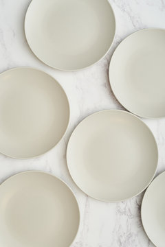 Empty plates on a marble background.