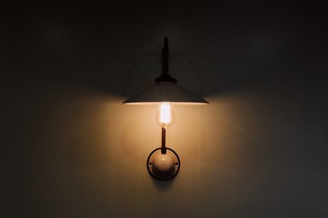 dim pendant lamp light hanging on an empty wall