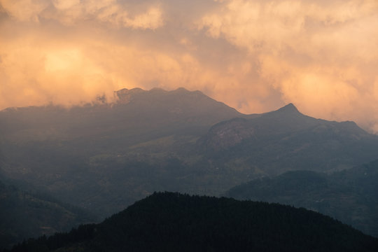 Orange clouds over the Knuckles mountain ridge