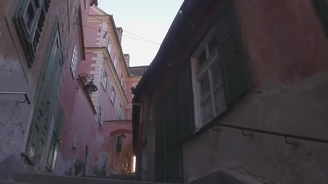 Walking through the old town. In the old town street. Walking through the streets of European town. Camera approaches through narrow street in an alley in a historic town signifying old city