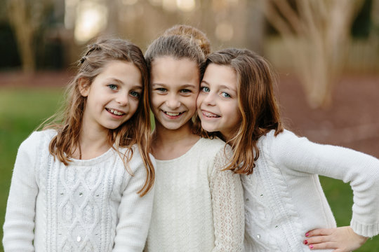 Close up of three sister standing together