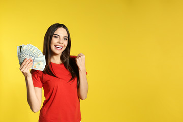 Young woman with money on color background. Space for text
