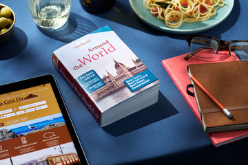 Travelling book around the world on dining table.