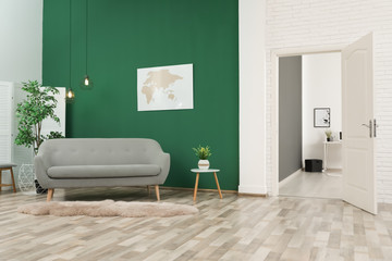 Living room interior with stylish furniture and open door