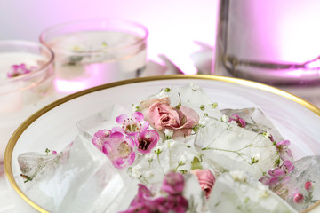 Bowl of floral ice cubes on table, closeup