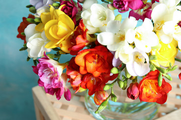 Beautiful spring bright freesia flowers on stand, closeup