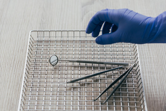 Orthodontist grabbing dental metallic tools