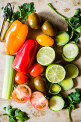 healthy food background, lime cut in half, celery, peppers, small colored tomatoes on a cutboard,top view.