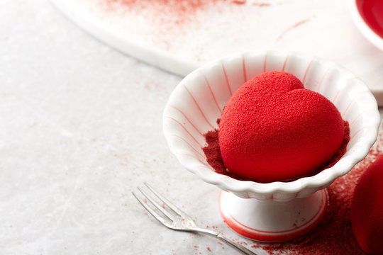 Red heart-shaped valentine cake on the dining table