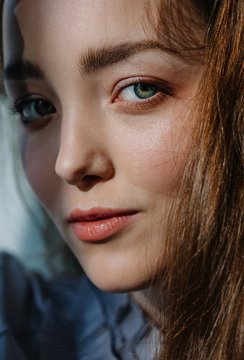 Closeup portrait of young pretty woman looking at camera