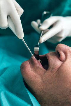 Dentist working on elderly man teeth