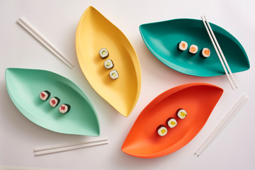 Sushi Rolls on Colorful Platters