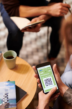 Woman browsing check in application on phone.