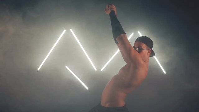 Sexy man dancing in smoke