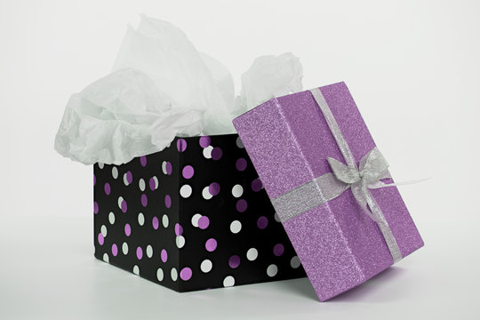 Polka Dot Gift Box With White Tissue Paper And Purple Glitter Lid Isolated On White