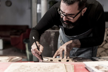 Guitar luthier working in his workshop