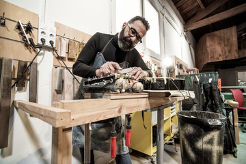Guitar luthier working in his workshop