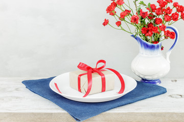 Empty plate on tablecloth or napkin on wooden table over cement background