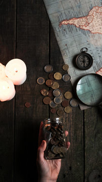 person holding a jar full of coins wondering wich is going to be the next travel destination