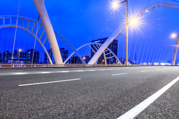Fototapeta na wymiar Empty asphalt road and bridge construction in shanghai at night
