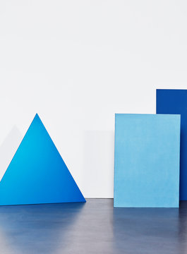 Blue shapes against a white wall.