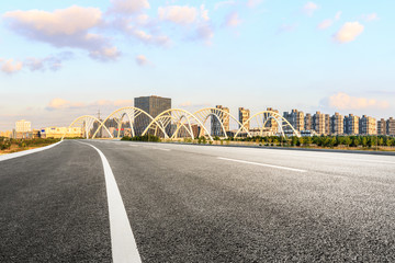 Fototapeta premium Asphalt road and city skyline with bridge construction in shanghai at sunset