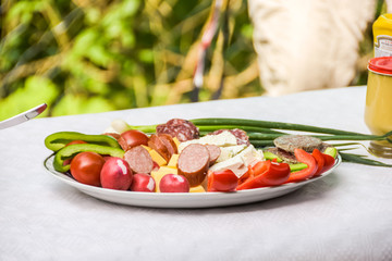 Balkan style appetizer plate with sausage and cheese