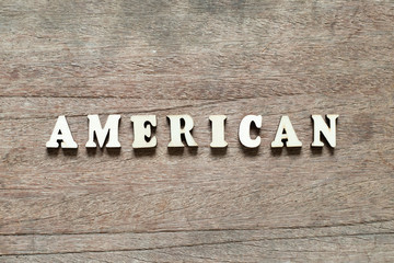 Letter block in word american on wood background