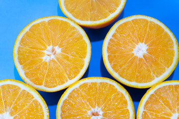 Orange halves on colorful background
