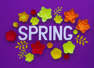 Spring hand lettering card. Spring tulip narcissus, plumeria paper flowers on dark Violet background.