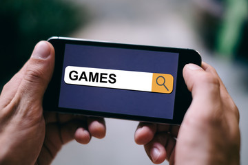 Games or Gaming Concept - Games written in search bar on mobile screen or smartphone display
