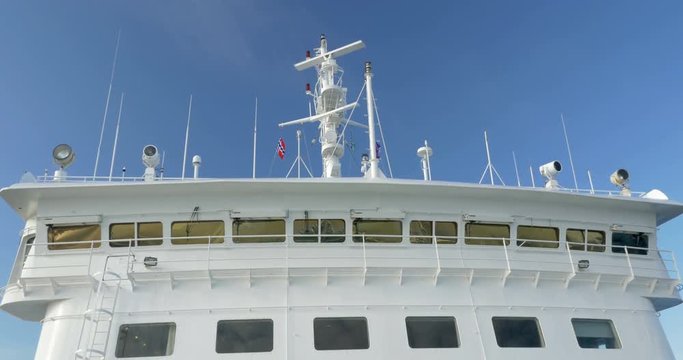 Front view of ship deck with antenna and radar rotating