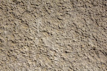 old white gray yellow shabby wall with deep uneven relief and shadows. rough surface texture