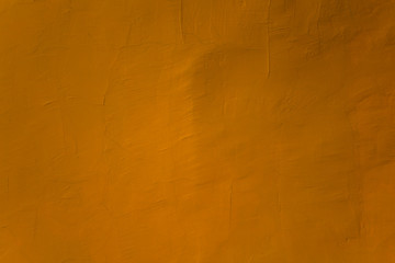 old yellow orange wall with cracks and scratches. rough surface texture