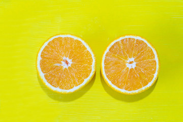 Orange halves on colorful background