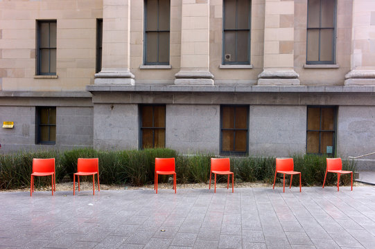 Red Chairs With Old Mint Building  In Background In San Francisco Old Mint Plaza