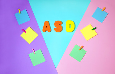 ASD. Autism spectrum disorder. Autism Concept with color paper stickers on blue background. Top view. Flat lay.